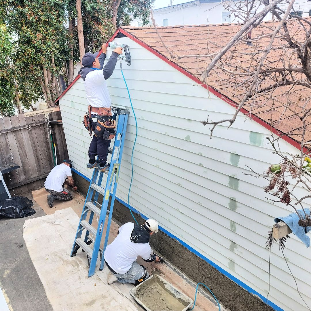 people working on house exterior