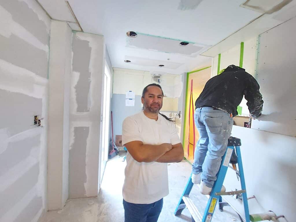 George overseeing drywall repairs during an interior remodel in Long Beach