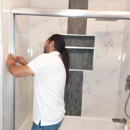 George installing a sliding shower door during a bathroom remodel in Long Beach